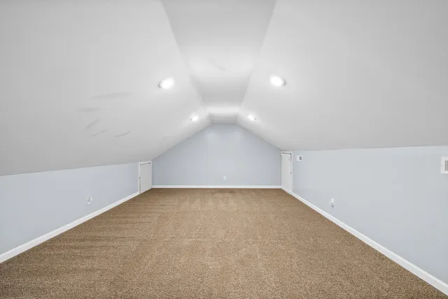 an empty room with windows and entrance