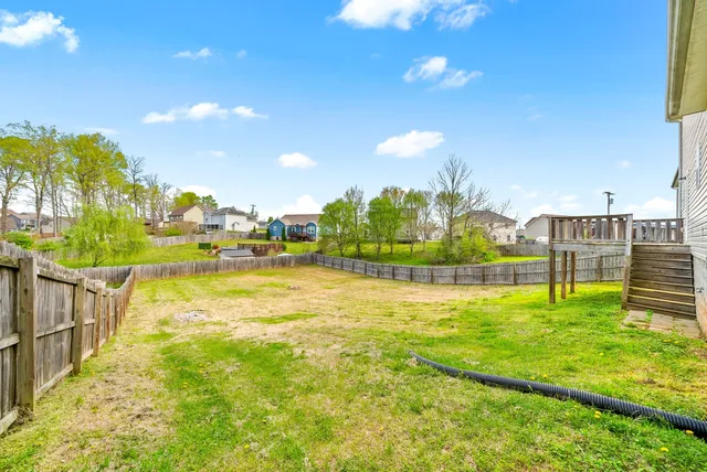 a view of a house with a backyard and a small pool