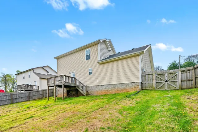 a view of a house with a backyard porch and a chair