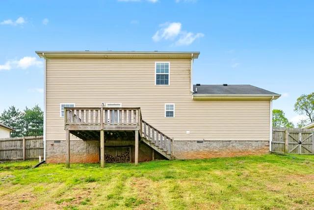 a view of a house with yard and sitting area