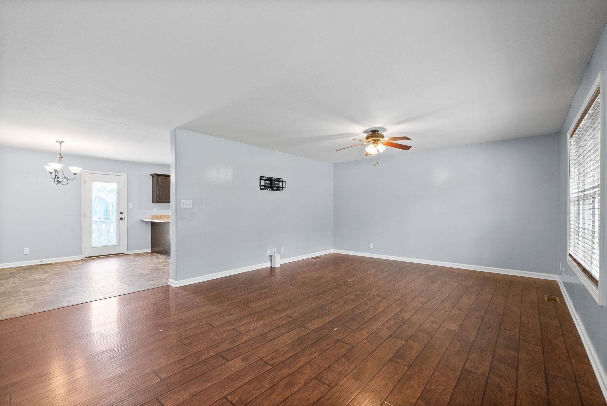 1563 Hazelwood Road Clarksville, TN 37042 - Photo 9 of 43 wooden floor in an empty room with a window