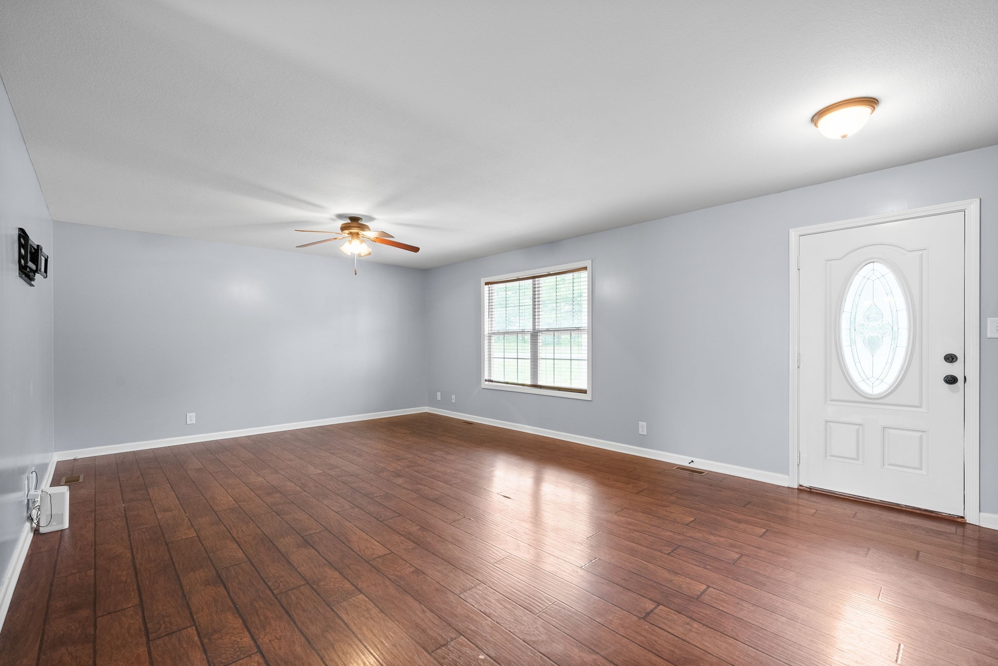 1563 Hazelwood Road Clarksville, TN 37042 - Photo 10 of 43 an empty room with wooden floor and windows