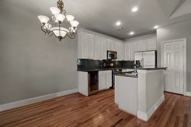 a kitchen with a refrigerator and a stove top oven
