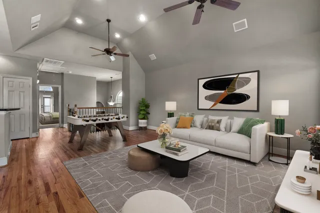 a living room with furniture and a wooden floor