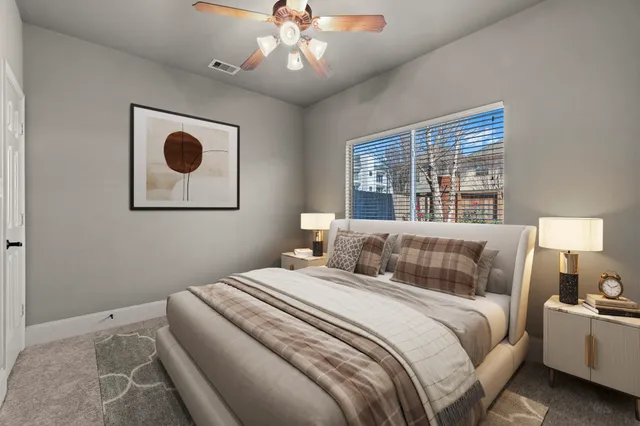 a bedroom with a large bed and a window