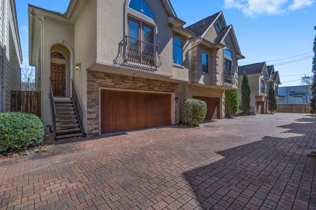 a view of a house with a yard and garage