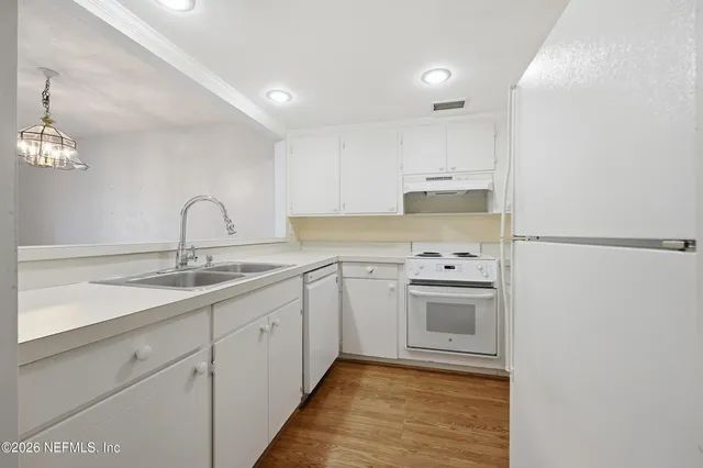 a kitchen with a sink cabinets and stainless steel appliances