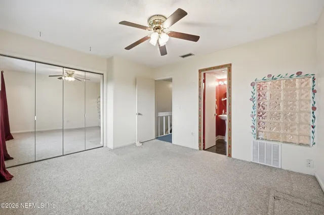 a view of empty room with ceiling fan