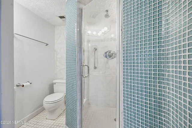 a bathroom with a toilet and shower