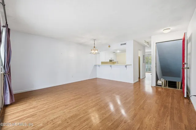 a view of a kitchen with a sink and a refrigerator