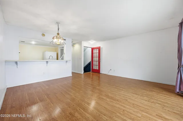 a view of a kitchen with a sink and a window