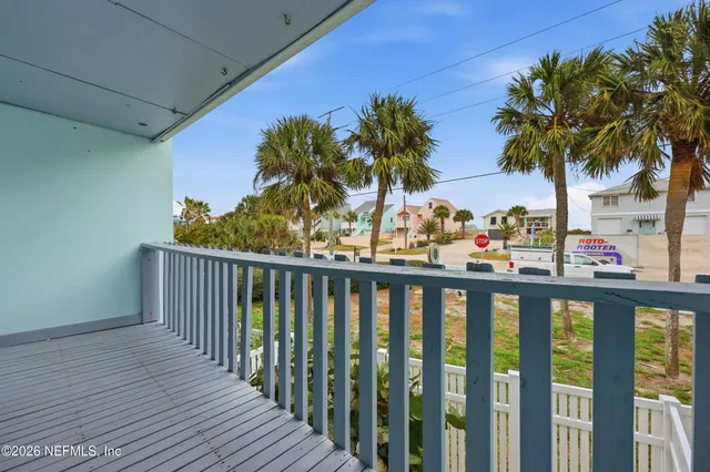 a view of a balcony with palm trees