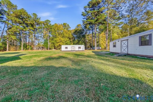 a view of a big yard with large trees