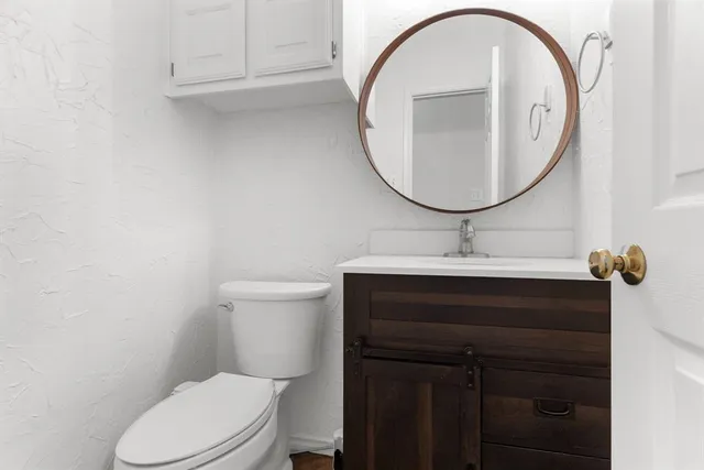 a bathroom with a sink a mirror and a toilet