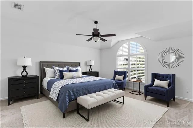 a bed room with a bed and a chair