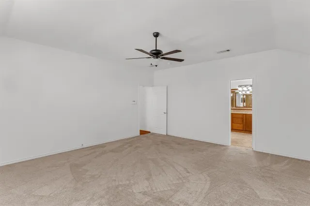 a view of a room with a ceiling fan