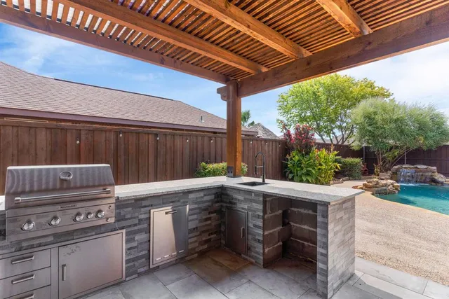 a view of a backyard with chairs and a grill