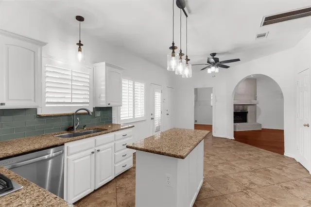 a kitchen with sink cabinets and chandelier