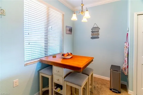 a view of a room that has a table and chairs in it