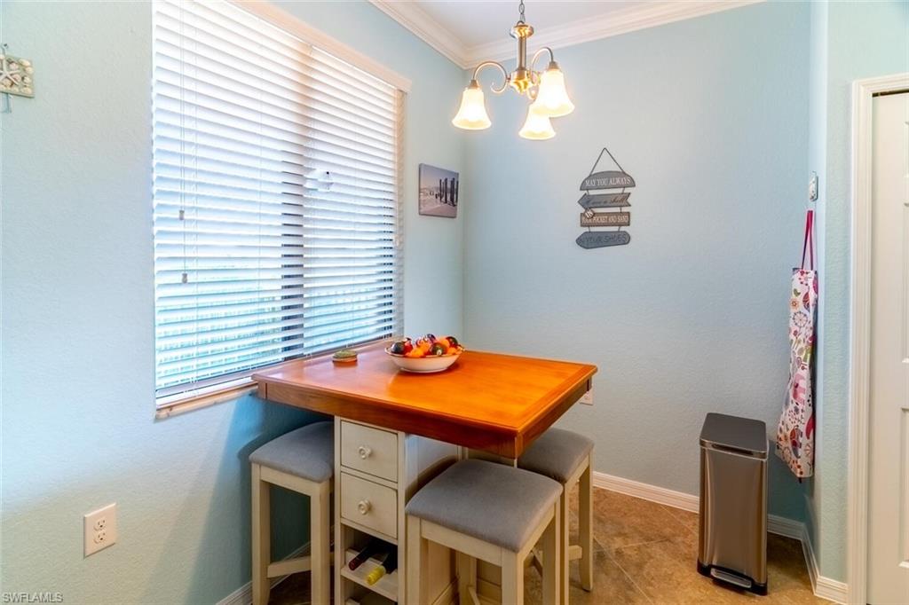 9723 Acqua Court, Unit 334 Naples, FL 34113 - Photo 11 of 49 a view of a room that has a table and chairs in it