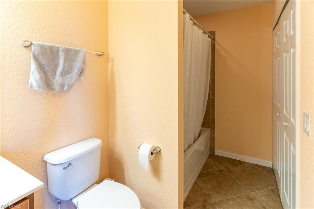9723 Acqua Court, Unit 334 Naples, FL 34113 - Photo 15 of 49 a bathroom with a toilet and shower