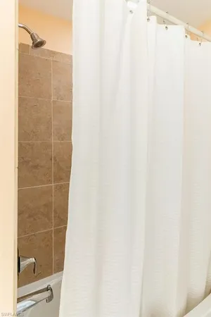 a bathroom with a shower curtain and a sink