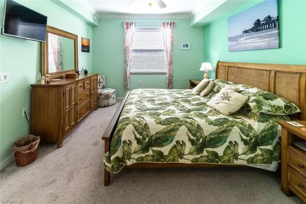 a bedroom with a bed and a tv