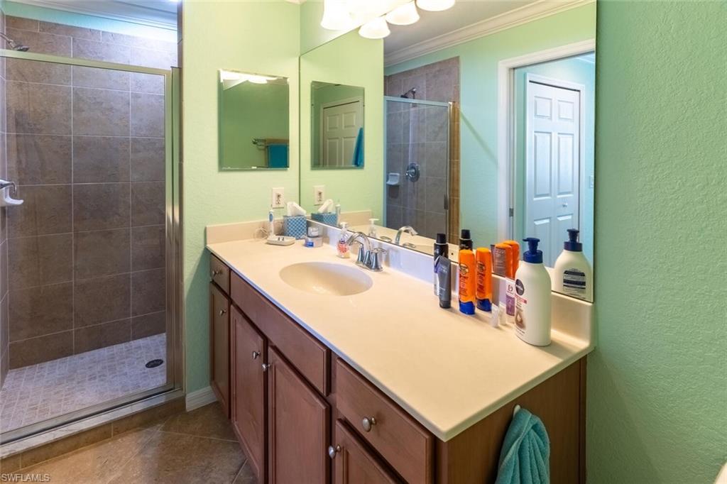 9723 Acqua Court, Unit 334 Naples, FL 34113 - Photo 21 of 49 a bathroom with a sink and a mirror