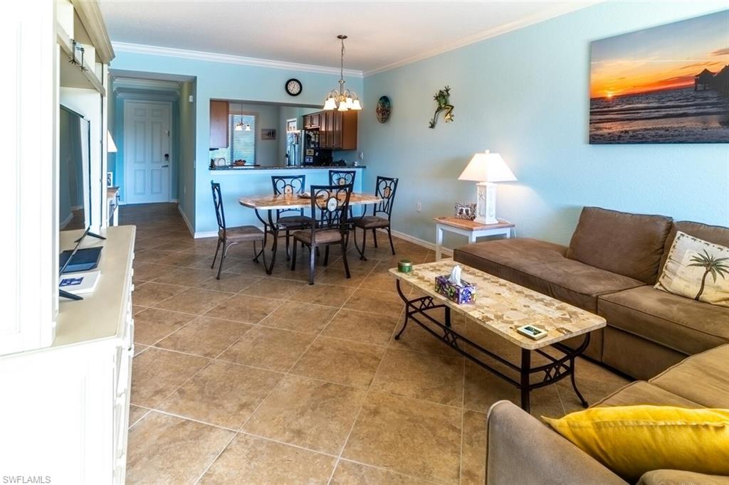9723 Acqua Court, Unit 334 Naples, FL 34113 - Photo 5 of 49 a living room with furniture and a dining area