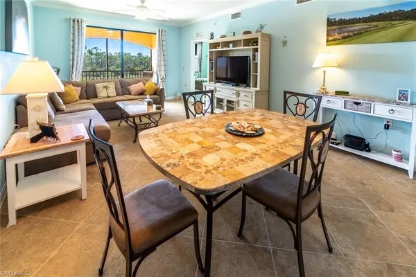 a view of a dining room with furniture and a flat screen tv