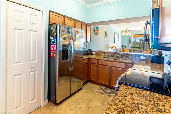 a kitchen with stainless steel appliances granite countertop a refrigerator and a sink