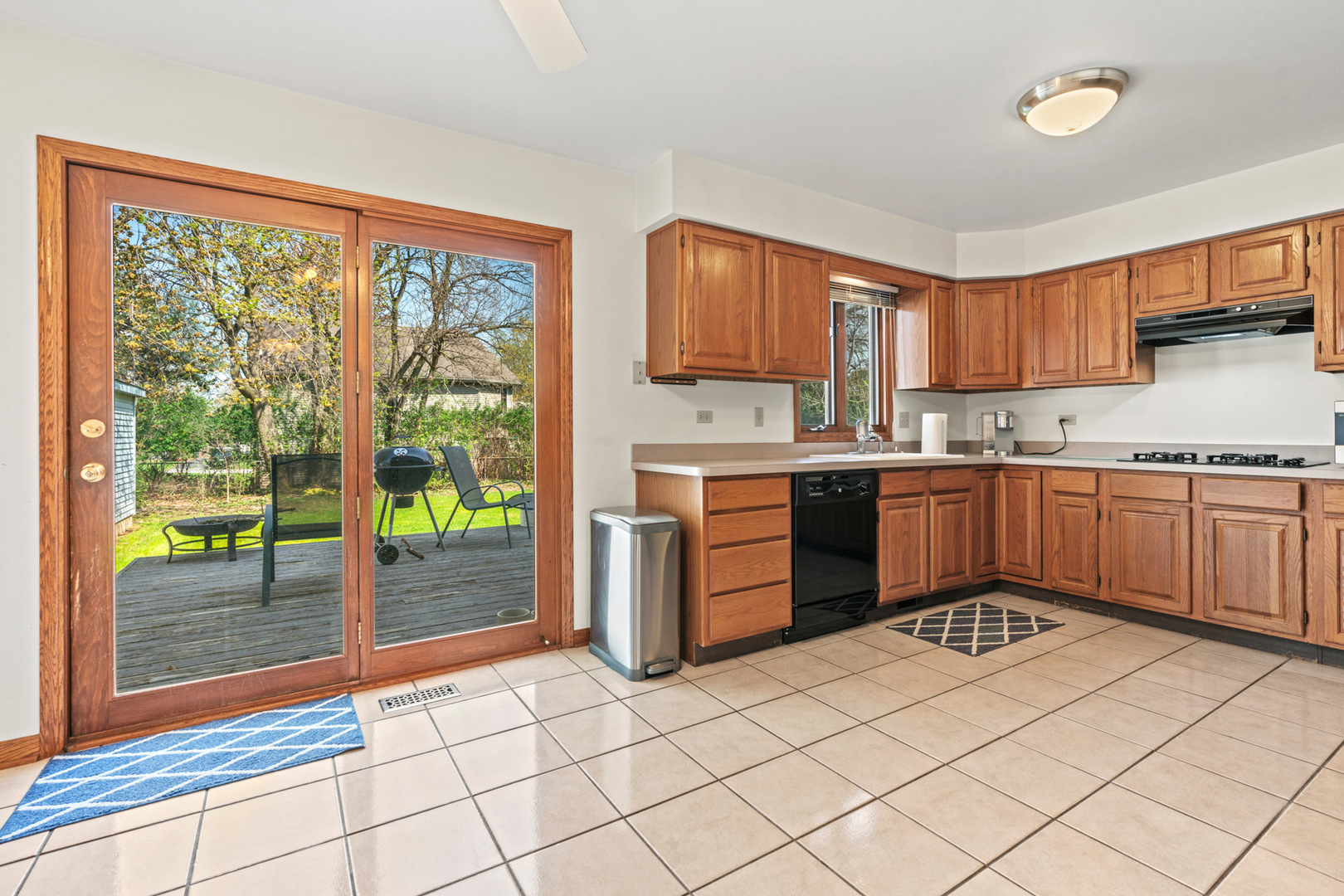 2344 Forest Avenue Rolling Meadows, IL 60008 - Photo 11 of 29 a kitchen with stainless steel appliances granite countertop a stove top oven a sink dishwasher and white cabinets next to a window