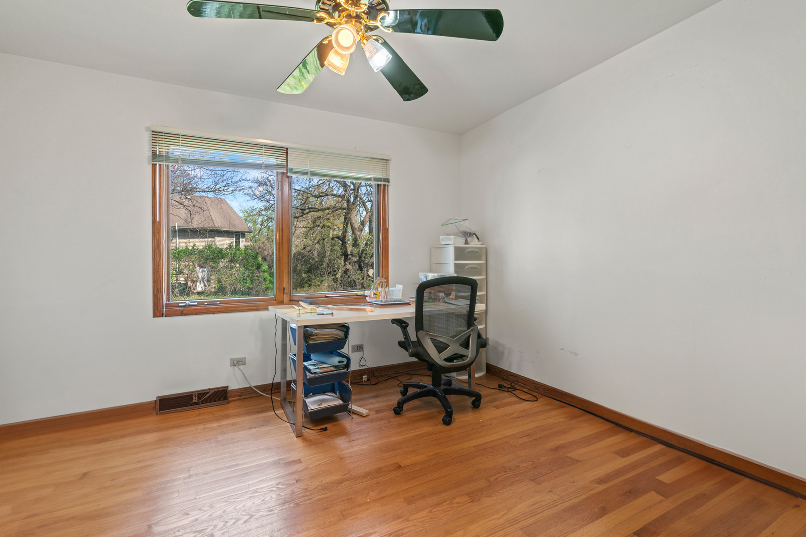 2344 Forest Avenue Rolling Meadows, IL 60008 - Photo 6 of 29 a view of a workspace with wooden floor and a window