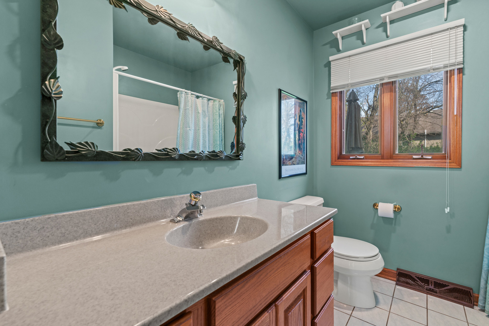 2344 Forest Avenue Rolling Meadows, IL 60008 - Photo 7 of 29 a bathroom with a sink a toilet and mirror