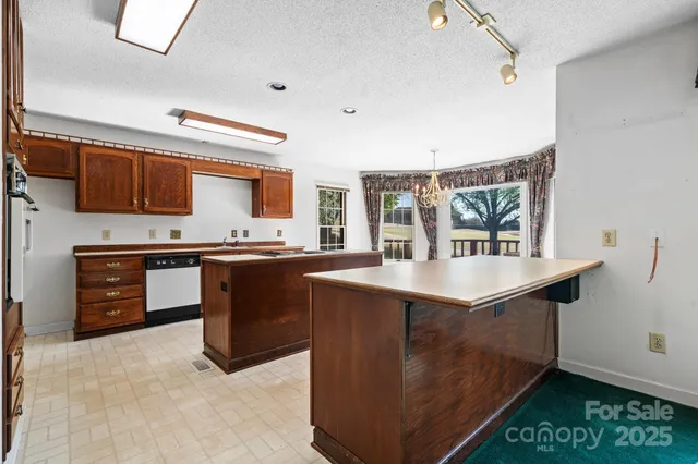 a kitchen with stainless steel appliances granite countertop a stove and a refrigerator