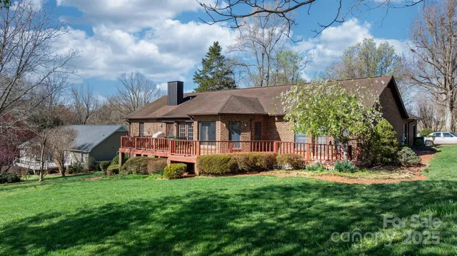 a front view of a house with a yard and potted plants