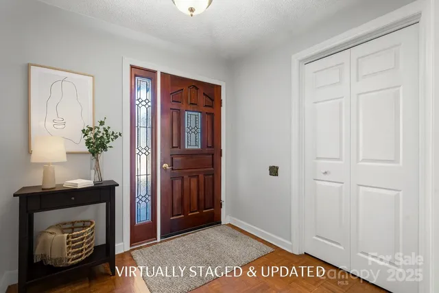 a living room with furniture a fireplace and a potted plant