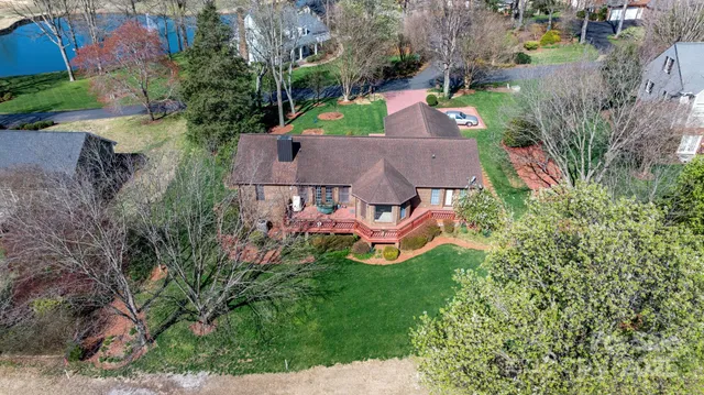 an aerial view of a house with yard swimming pool and outdoor seating