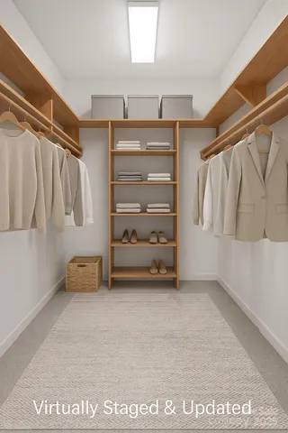 a view of walk in closet with clothes and shoes