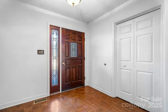 a view of a big room with windows and cabinet