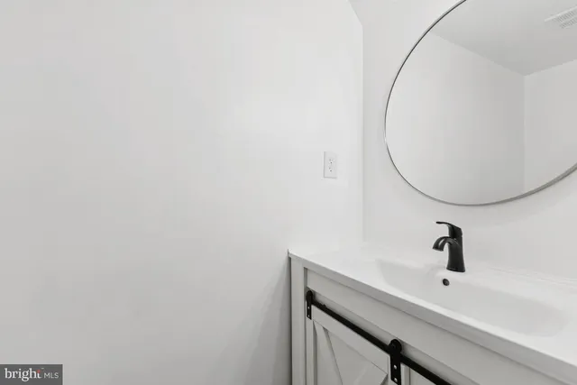 an empty room with wooden floor and a window