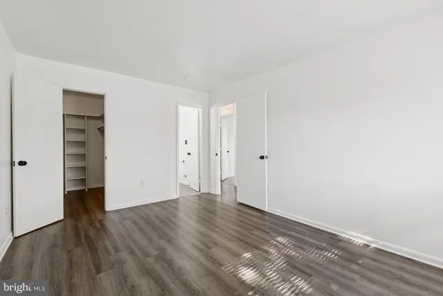 a view of walk in closet with empty racks