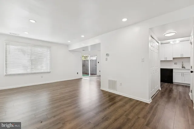 a view of a kitchen with a sink and wooden floor