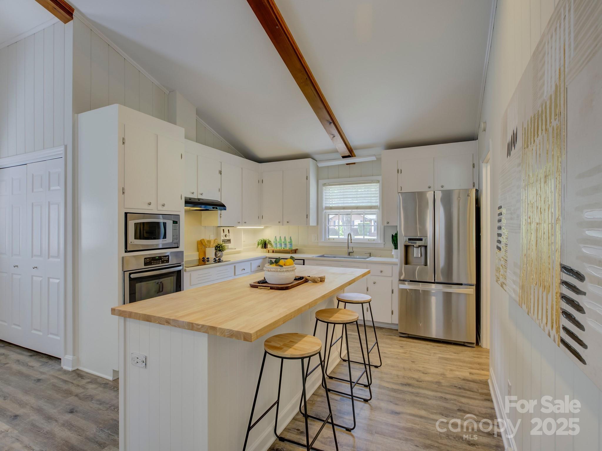 5601 Londonderry Road Charlotte, NC 28210 - Photo 13 of 42 a kitchen with stainless steel appliances a refrigerator stove microwave and cabinets