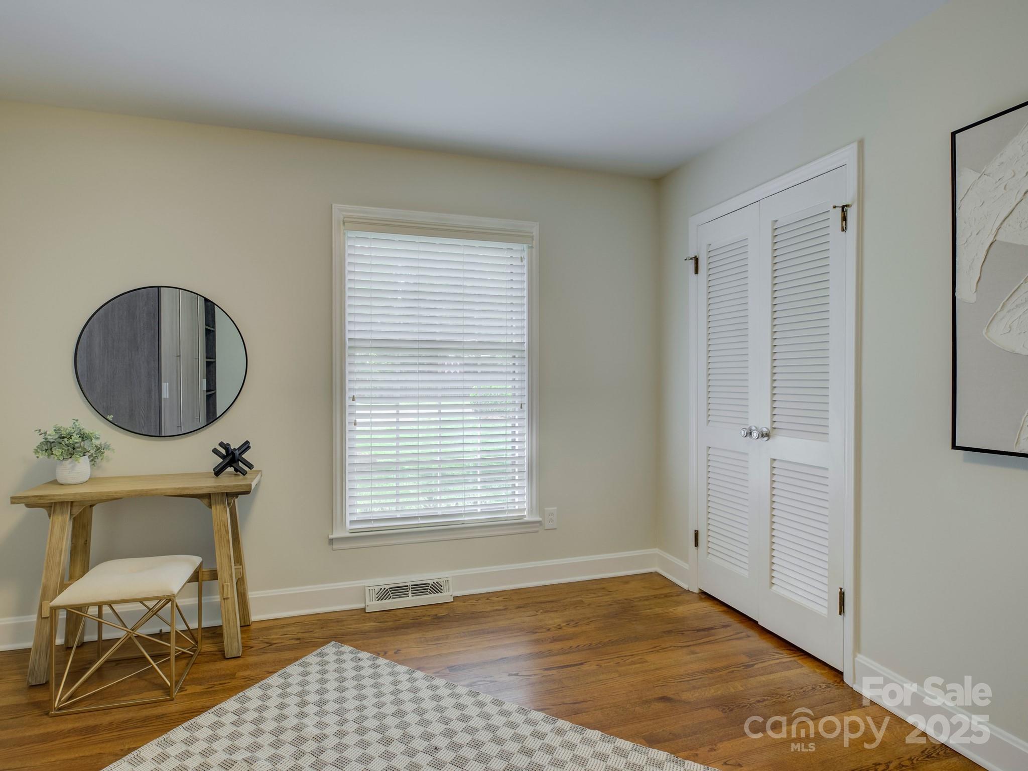 5601 Londonderry Road Charlotte, NC 28210 - Photo 20 of 42 a view of empty room with wooden floor and chair