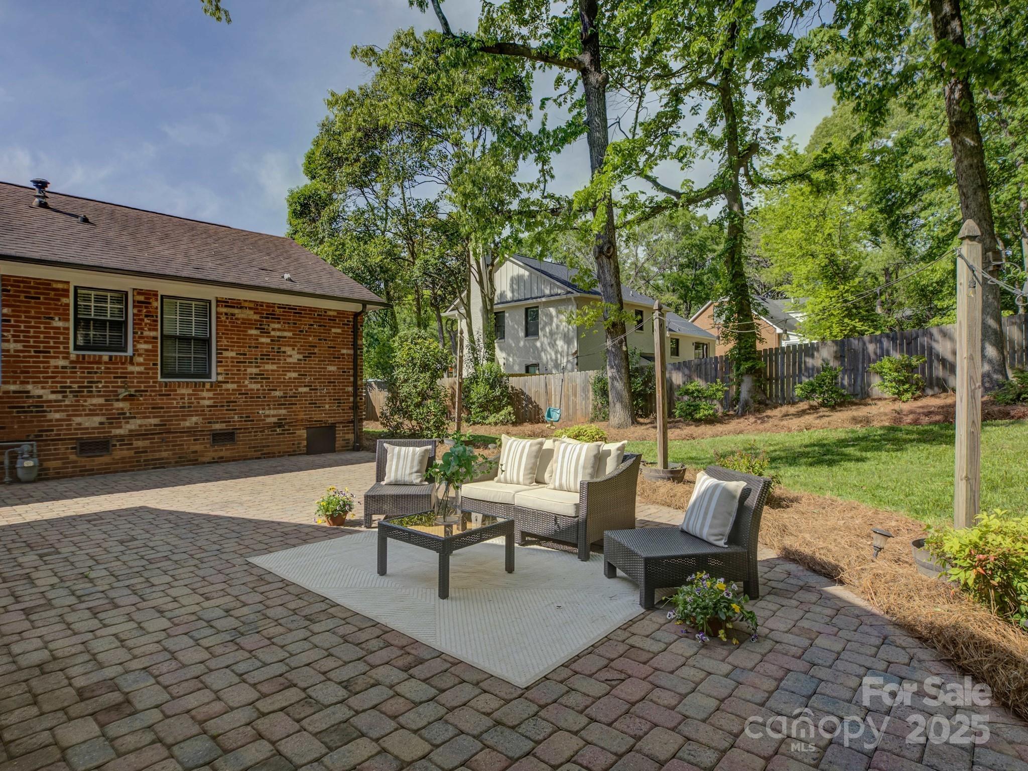 5601 Londonderry Road Charlotte, NC 28210 - Photo 34 of 42 a view of a patio with a table and chairs and garden