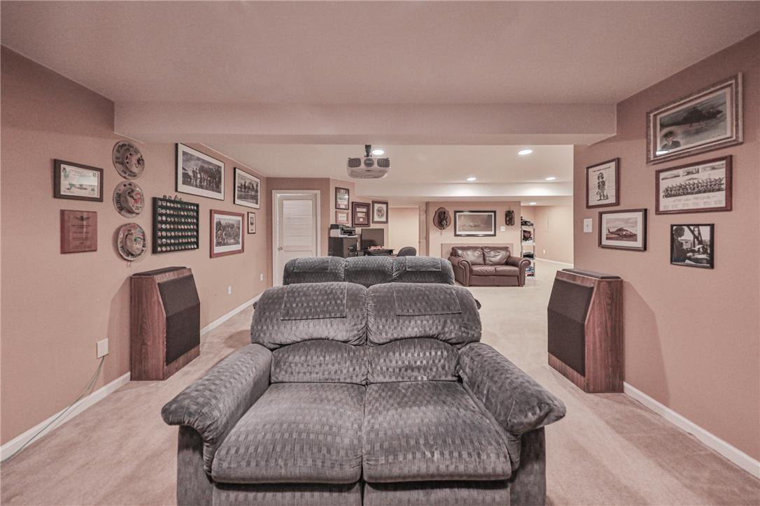 138 Clover Hollow Road Easton, PA 18045 - Photo 69 of 95 A well-lit entertainment space featuring a projector and plush seating for ultimate relaxation.