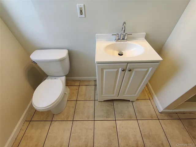 a bathroom with a sink toilet and a mirror