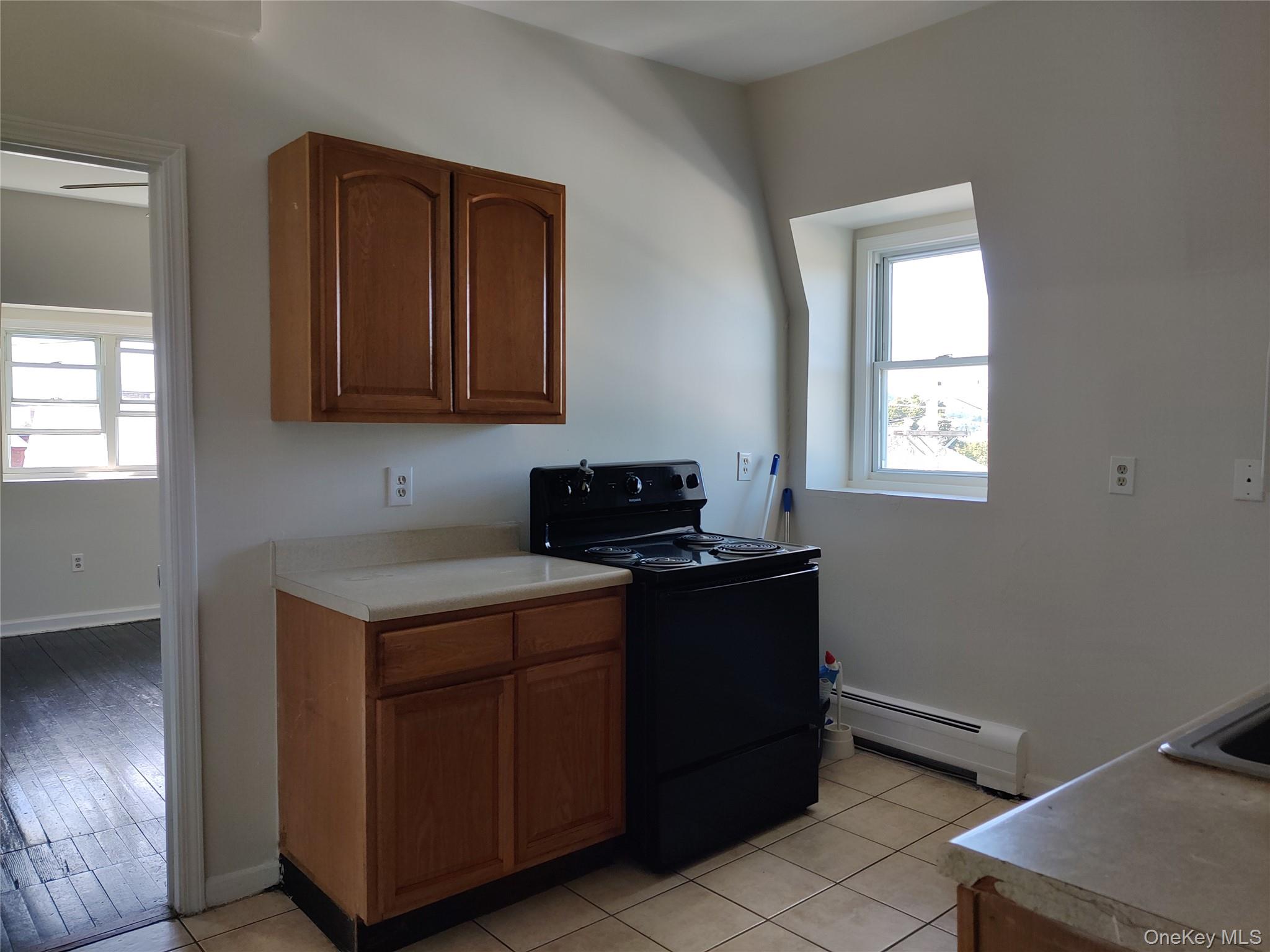 219 Mill Street, Unit 4 Poughkeepsie, NY 12601 - Photo 8 of 18 a kitchen with a cabinets and window