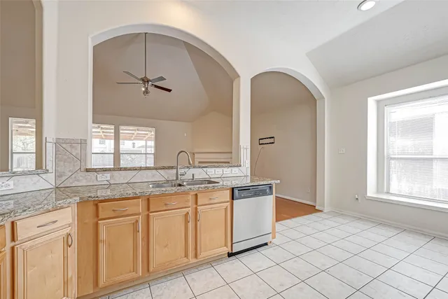 a spacious bathroom with a granite countertop sink a mirror and with